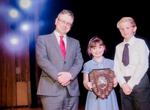 Year 3 pupil Jessica Moffatt and Year 6 pupil Matthew Hawes collect the award on behalf of Diggle School